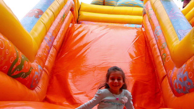 oung girl having fun on inflatable playground
