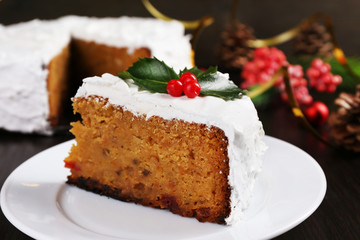 Fototapeta na wymiar Slice of cake covered cream with Christmas decoration