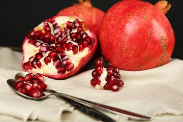 Juicy ripe pomegranates on dark background