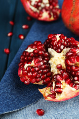 Juicy ripe pomegranates on wooden table