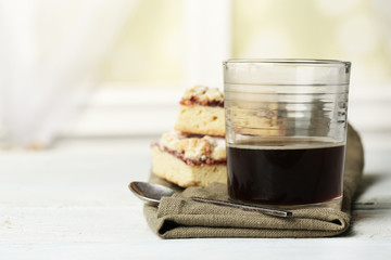 Glass of espresso and tasty homemade pie on wooden table