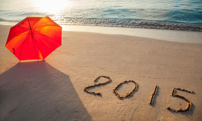 Peaceful seashore with 2015 drawn on  sand