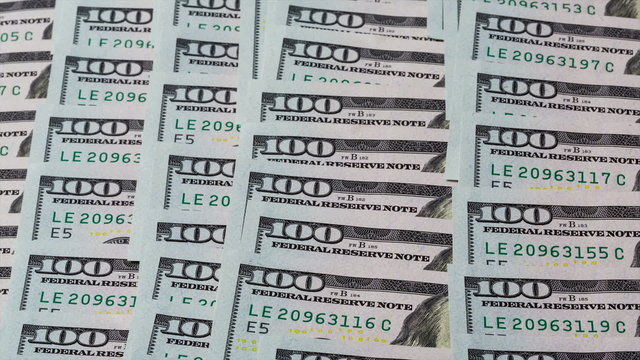 Layers of cash spreading across the table