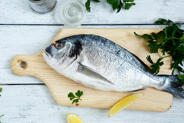 Fresh sea bream and paper