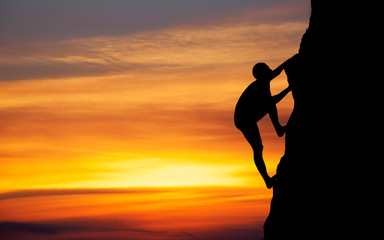 Rock climber at sunset background. Sport and active life