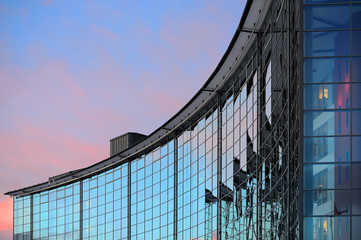 Glass facade of office building in sunset