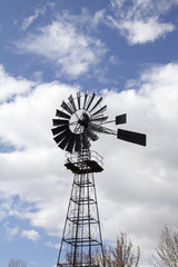 Windmill against blue cloudy sky