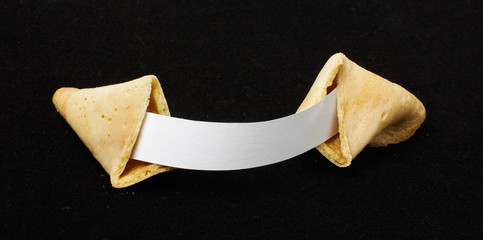 Open chinese fortune cookie isolated on the black background