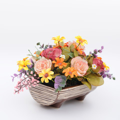 Many colorful flowers in wooden pot, artificially