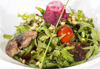 rabbit liver salad with arugula in a restaurant