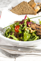 rabbit liver salad with arugula in a restaurant