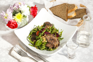 rabbit liver salad with arugula in a restaurant