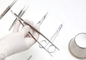 metallic surgical instrument in the surgeon's hand