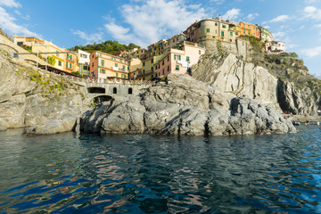 Manarola village, rocks and sea at sunset. Cinque Terre, Italy