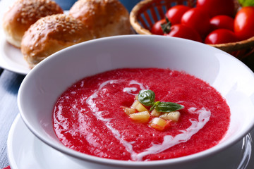 Gazpacho soup on color wooden background