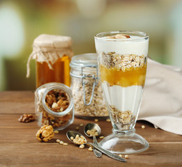 Tasty dessert with oat flakes and honey, on table
