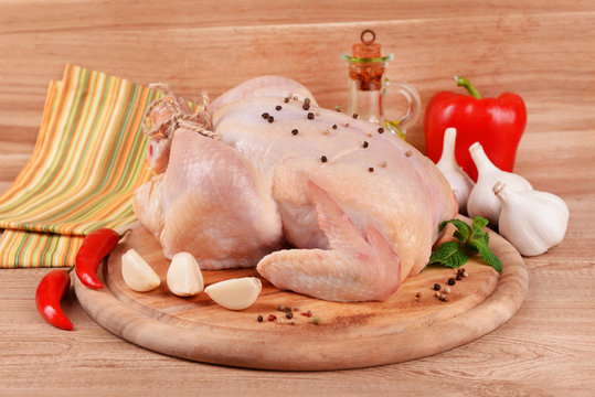 Raw chicken on wooden table