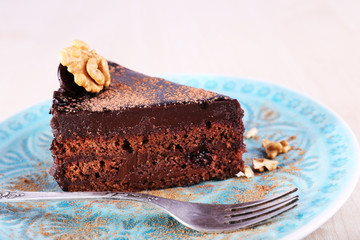Delicious chocolate cake on plate on bright background