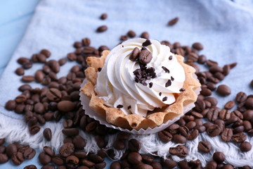 Cake with cream and spilled coffee beans