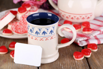 Cup of tea with card on table close-up