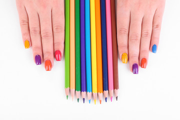 Multicolor female manicure with colored pencils isolated