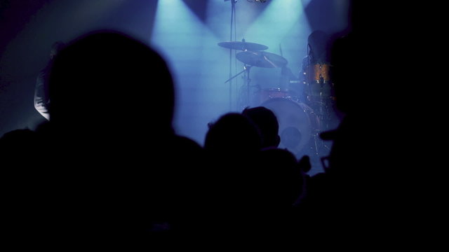People listening man playing on percussion on a concert