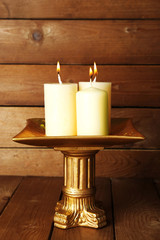 Retro candlestick with candles on wooden background