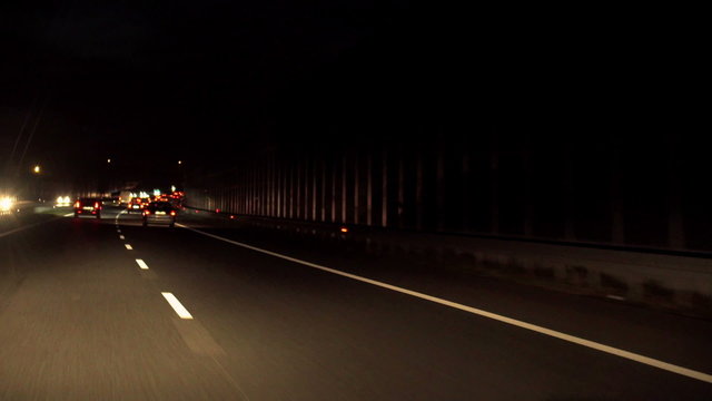 View of cars riding on highway at night