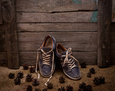 blue man's casual shoe on wooden background
