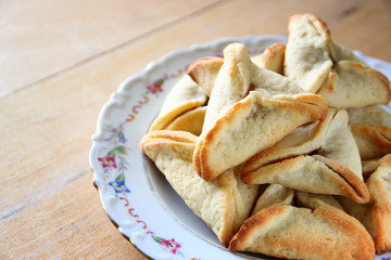 Hamantaschen cookies or hamans ears and noisemaker for Purim cel