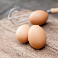 Fresh farm eggs on a wooden rustic background