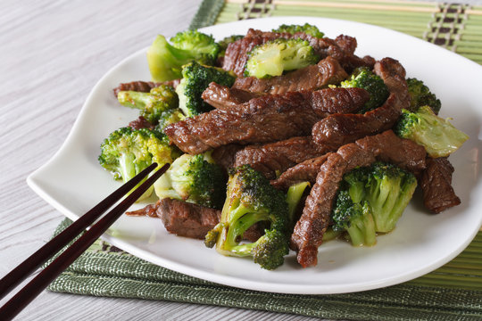 beef with broccoli closeup and chopsticks. horizontal