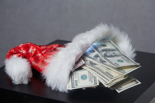 money in a Christmas cap Santaklaus