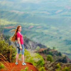 Woman enjoying stunning view into Waimea Canyon