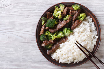 beef with broccoli and rice on the table. horizontal top view