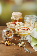 Tasty dessert with oat flakes and honey, on table