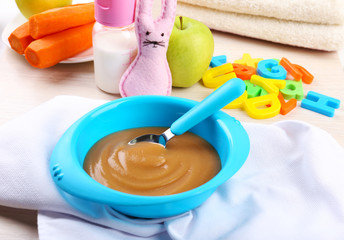 Fresh baby food in bowl with spoon