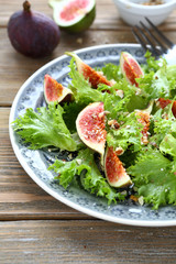 Fresh salad with figs and lettuce on a plate