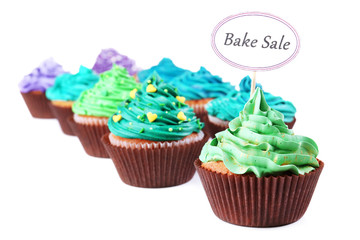 Delicious cupcakes with inscription isolated on white