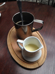 Cup of black coffee and milk on the wooden table