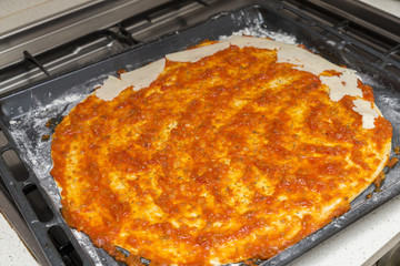 preparing the pizza dough with tomato