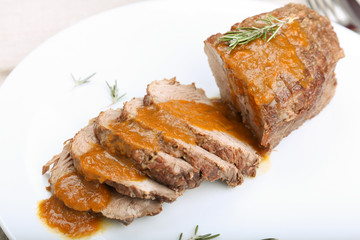Slices of veal roll with sauce.