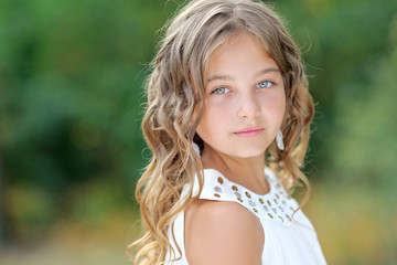 Fototapeta premium portrait of little girl outdoors in summer