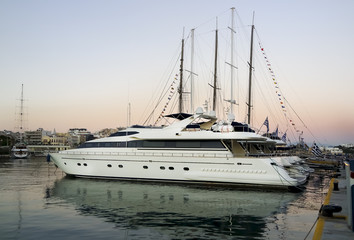 Fototapeta premium Sunstet and Luxury motor boat at marina,Greece