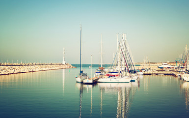 Fototapeta na wymiar romantic marina with yachts. retro filtered image 