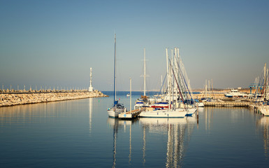 Fototapeta na wymiar romantic marina with yachts. retro filtered image 