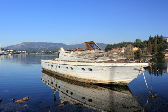 shipwrecked abandoned motor boat	