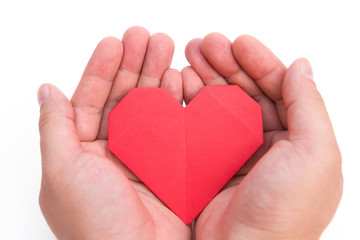 Fototapeta premium hands holding an origami heart