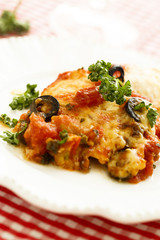 Baked fish with olives, herbs and tomatoes