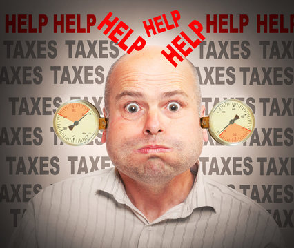 Frustrated businessman under pressure. High taxes concept.